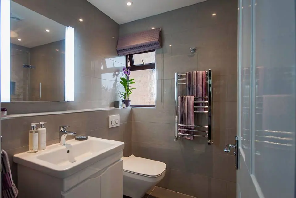 Living space detail showing custom shelving and lighting