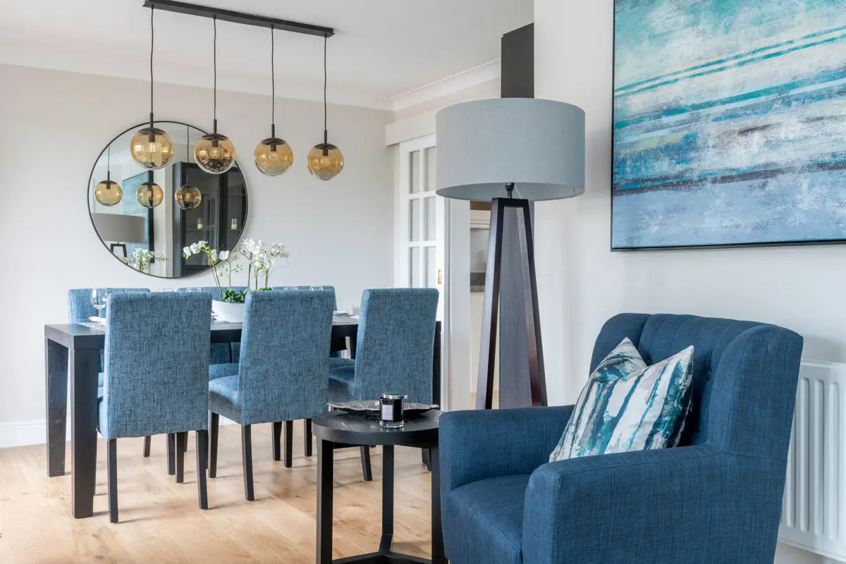 Styled show home entrance hall with statement lighting